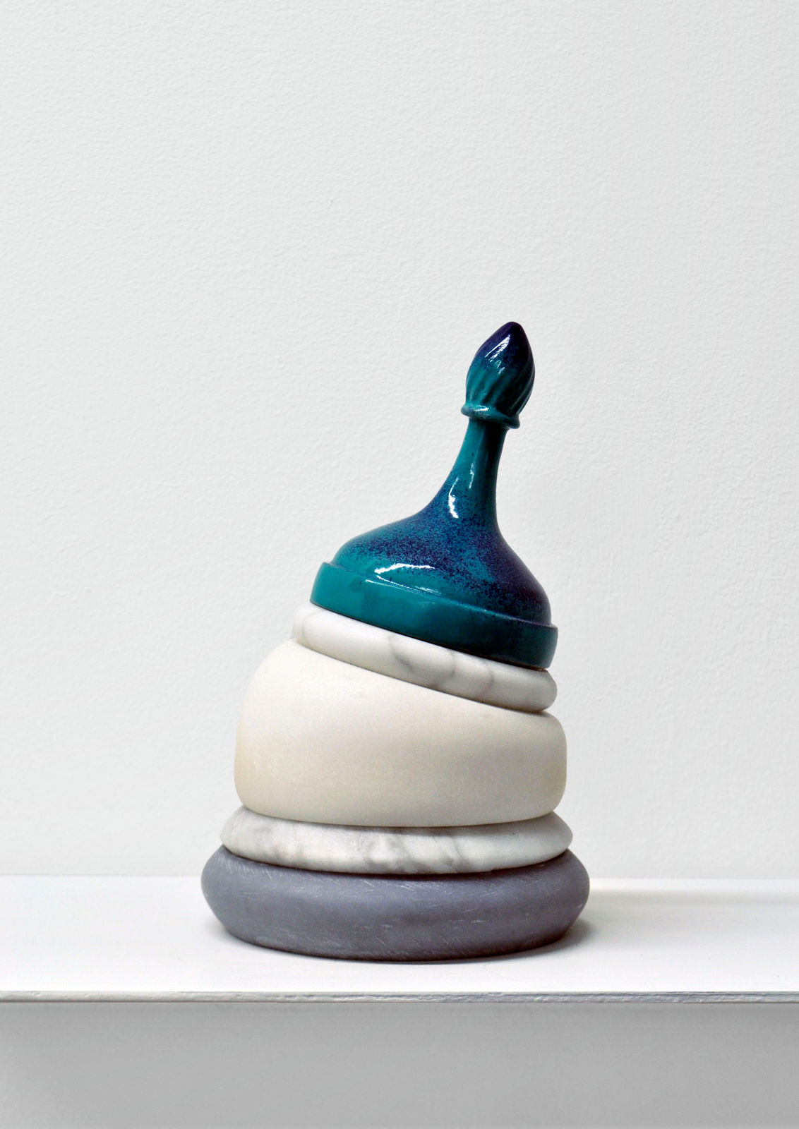 Contemporary minimalist sculpture made of stone and metal that resembles an ambiguous artifact