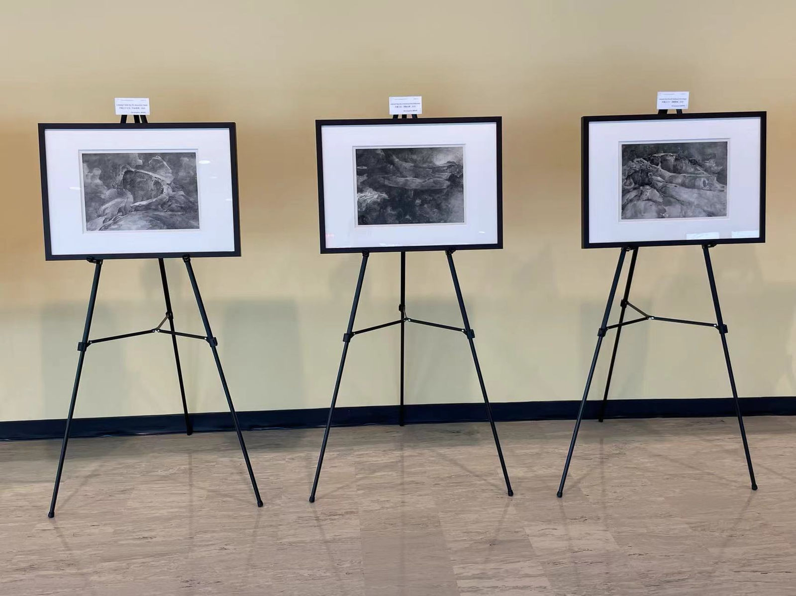 three paintings by Tai Xiangzhou, exhibiting on tripod stands