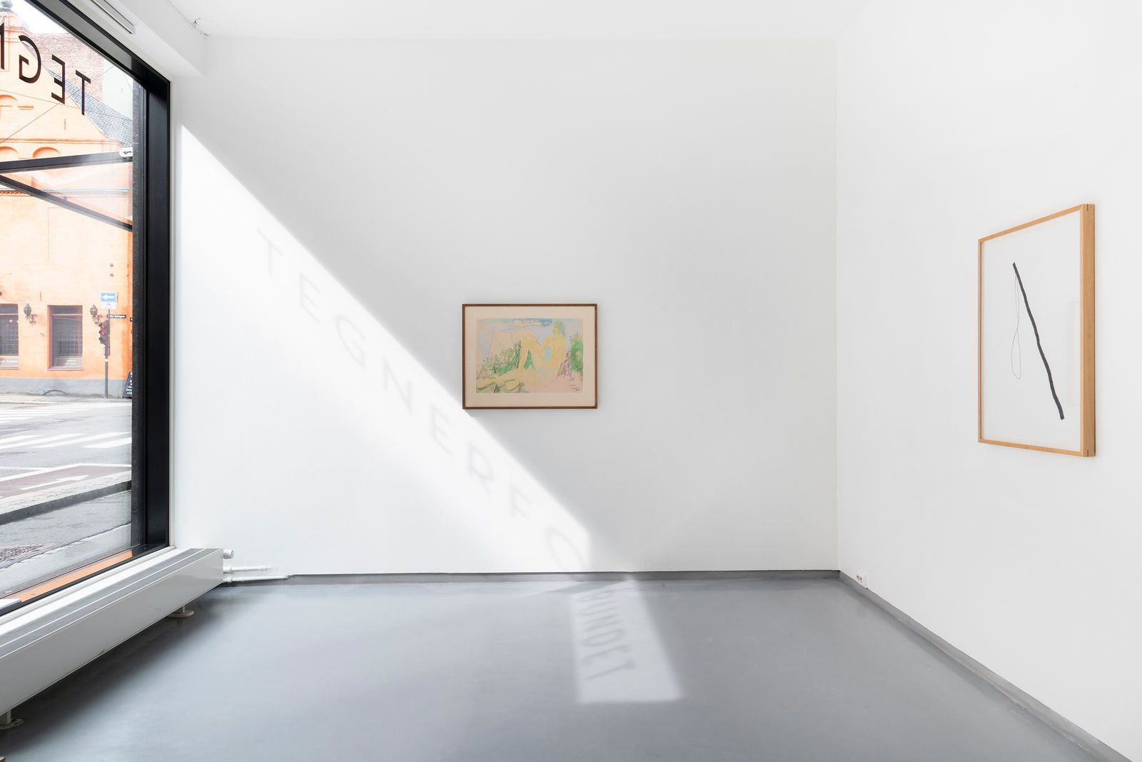 Two framed graphite line drawings by Inger Johanne Grytting hang on a white wall in a gallery like space in Oslo, Norway