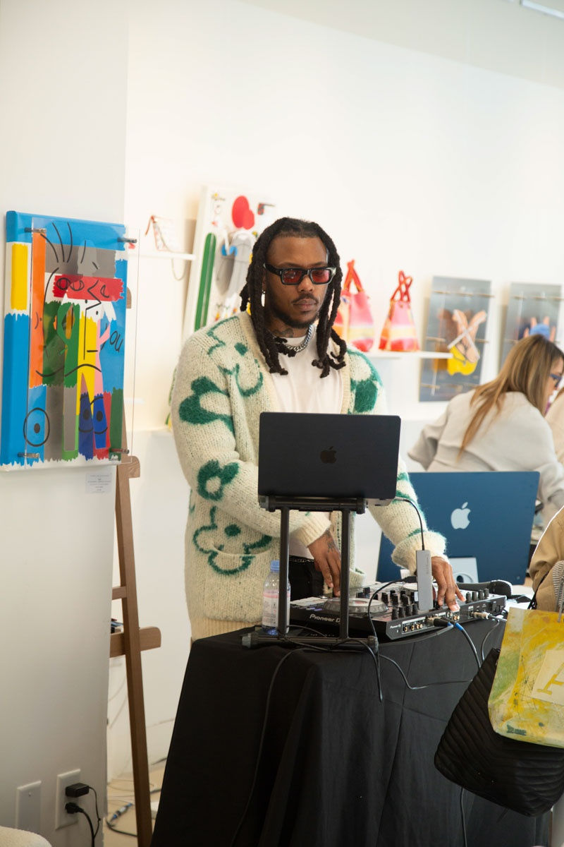 DJ playing at Carousel Fine Art's gallery space in Buckhead Village, Atlanta during the Caroline Dechamby Retrospective.