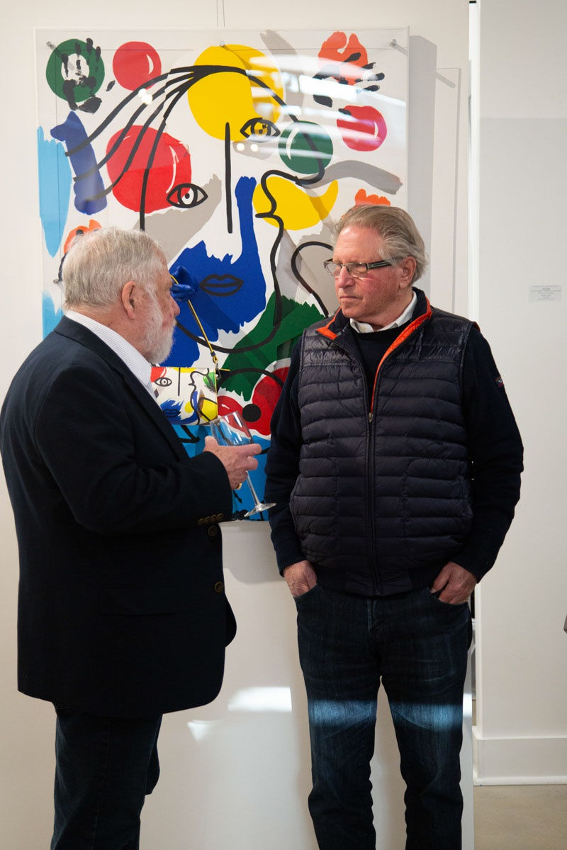 Men talking at Carousel Fine Art's gallery space in Buckhead Village, Atlanta during the Caroline Dechamby Retrospective.