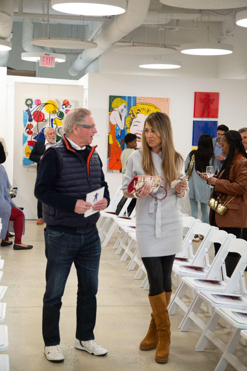 People talking at Carousel Fine Art's gallery space in Buckhead Village, Atlanta during the Caroline Dechamby Retrospective.