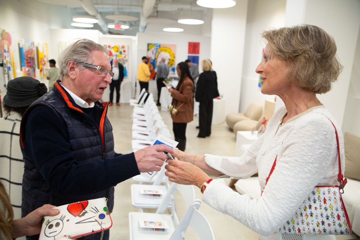 People at Carousel Fine Art's gallery space in Buckhead Village, Atlanta during the Caroline Dechamby Retrospective.