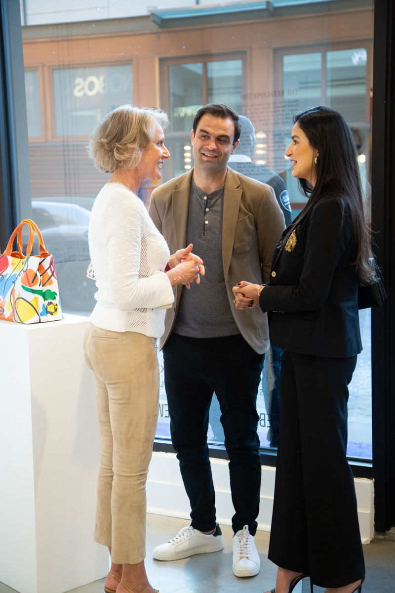 People talking at Carousel Fine Art's gallery space in Buckhead Village, Atlanta during the Caroline Dechamby Retrospective.