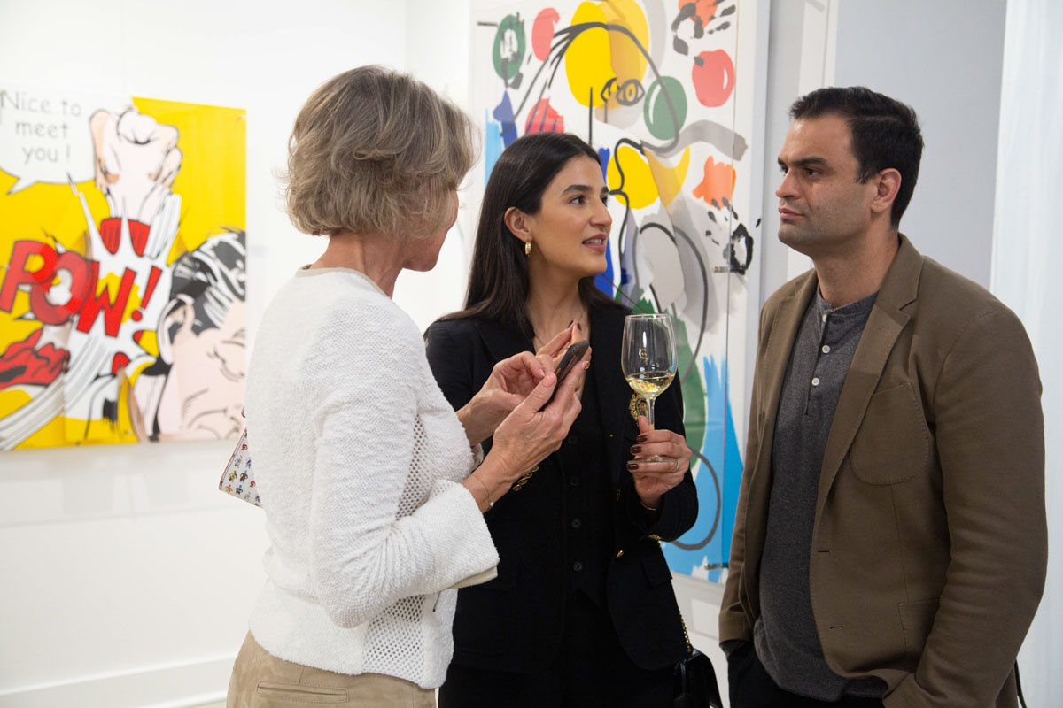 People at Carousel Fine Art's gallery space in Buckhead Village, Atlanta during the Caroline Dechamby Retrospective.