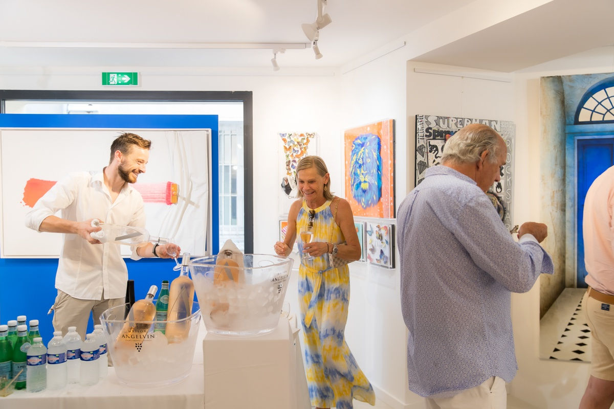 People inside of Carousel Fine Art's gallery space in Saint Tropez.
