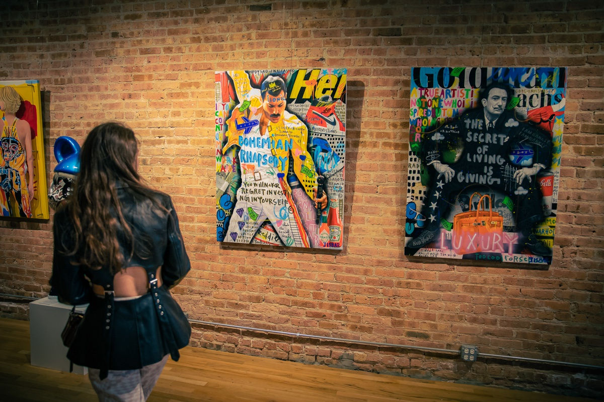 Woman staring at paintings in Carousel Fine Art's Chicago gallery space.