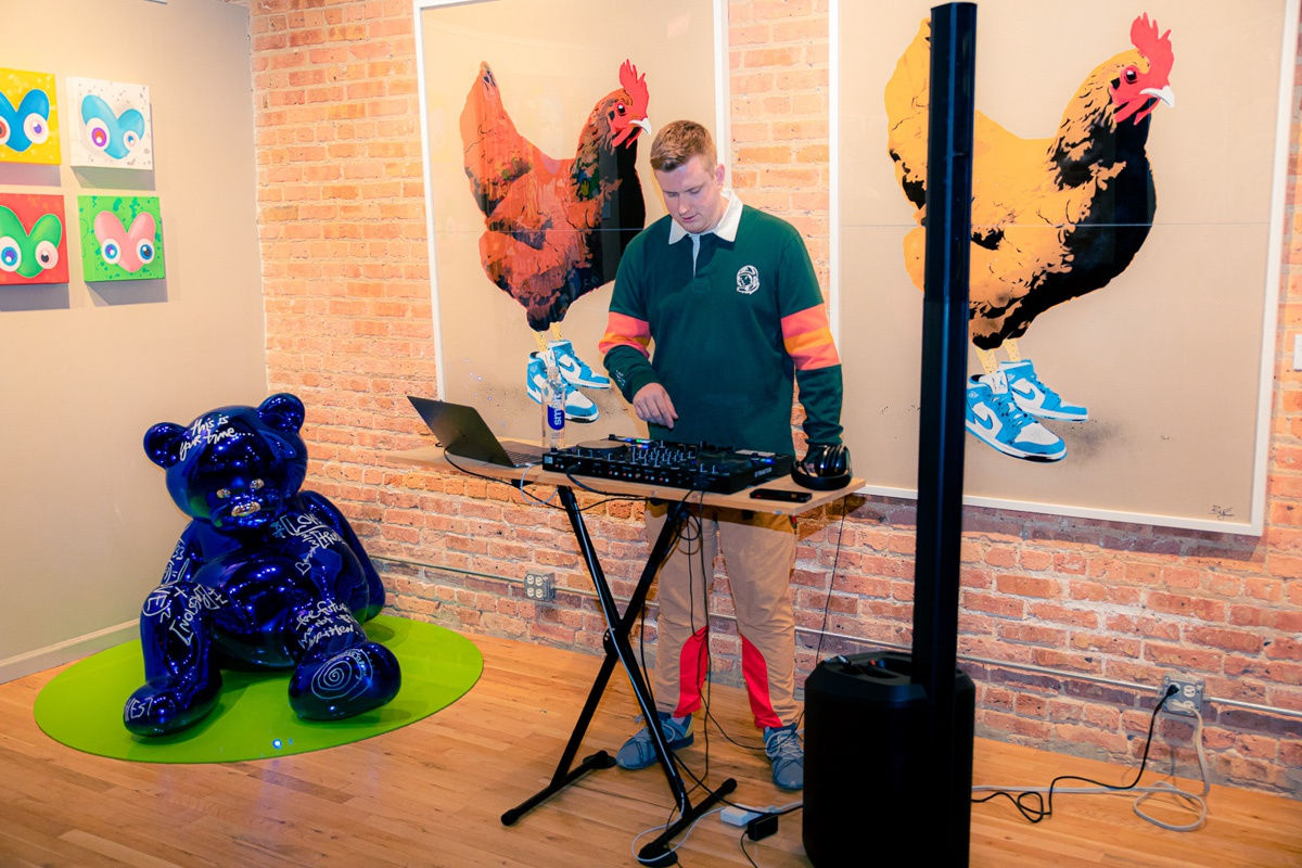DJ playing music in Carousel Fine Art's Chicago gallery space.