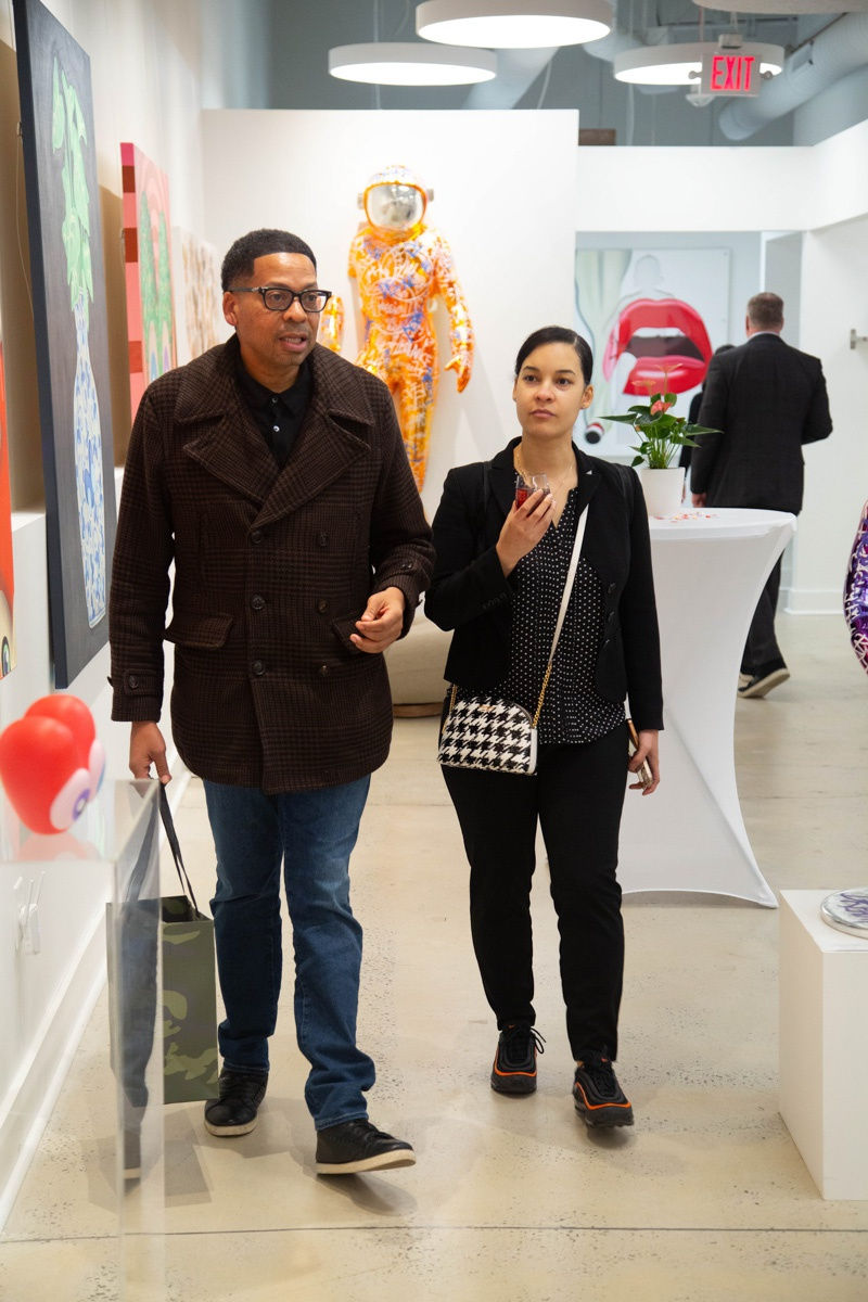 People in Carousel Fine Art's Atlanta gallery space during the spotlight exhibition for John Westbay titled "Love, Outside the Lines."