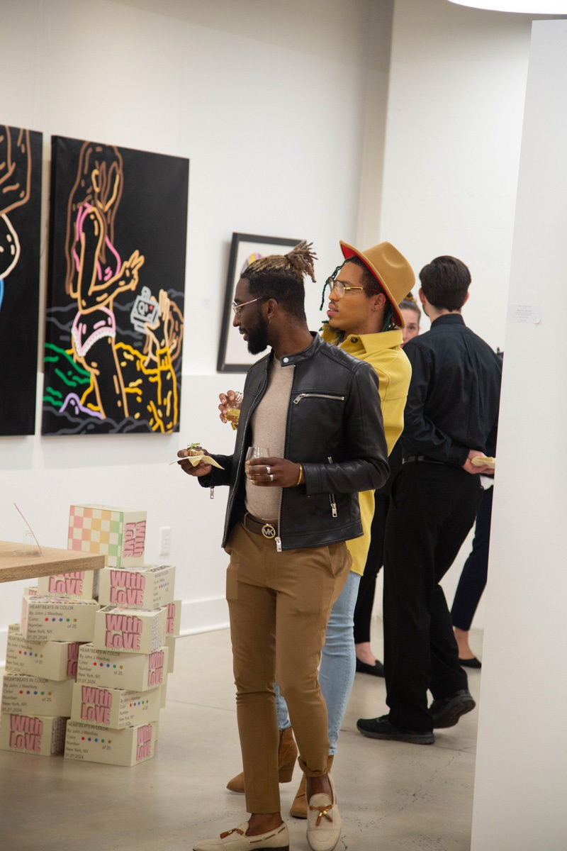 People in Carousel Fine Art's Atlanta gallery space during the spotlight exhibition for John Westbay titled "Love, Outside the Lines."