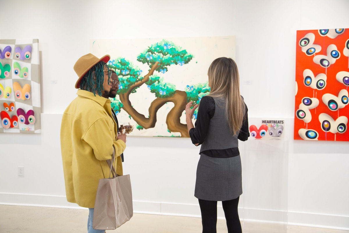 People in Carousel Fine Art's Atlanta gallery space during the spotlight exhibition for John Westbay titled "Love, Outside the Lines."