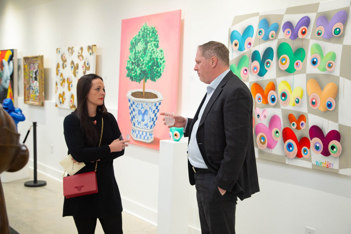 People in Carousel Fine Art's Atlanta gallery space during the spotlight exhibition for John Westbay titled "Love, Outside the Lines."