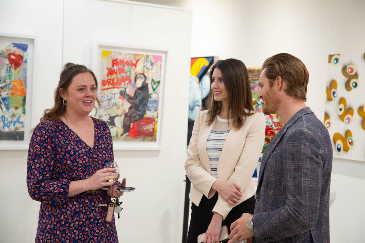 People in Carousel Fine Art's Atlanta gallery space during the spotlight exhibition for John Westbay titled "Love, Outside the Lines."