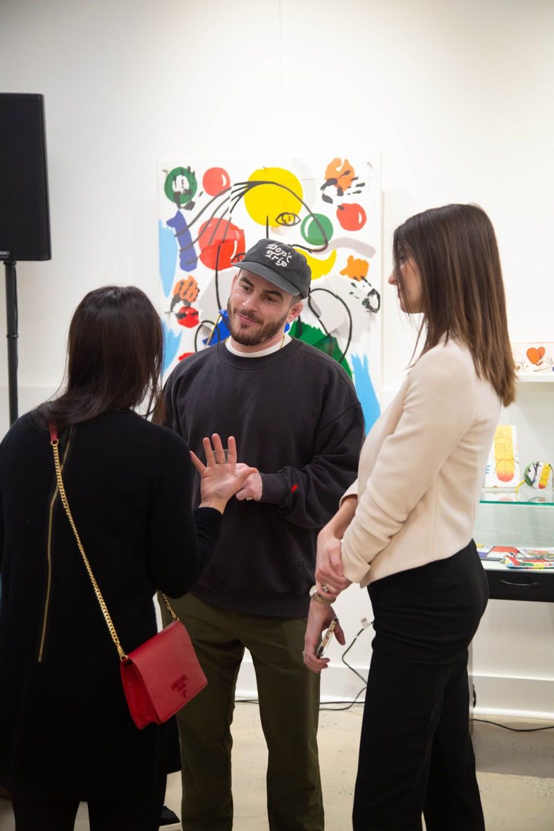 People talking in Carousel Fine Art's Atlanta gallery space during the spotlight exhibition for John Westbay titled "Love, Outside the Lines."