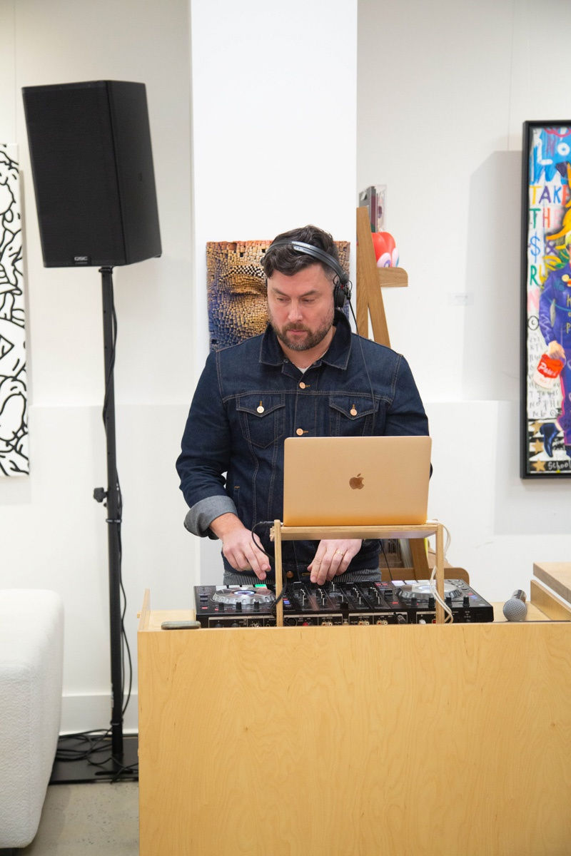 DJ playing music in Carousel Fine Art's Atlanta gallery space during the spotlight exhibition for John Westbay titled "Love, Outside the Lines."
