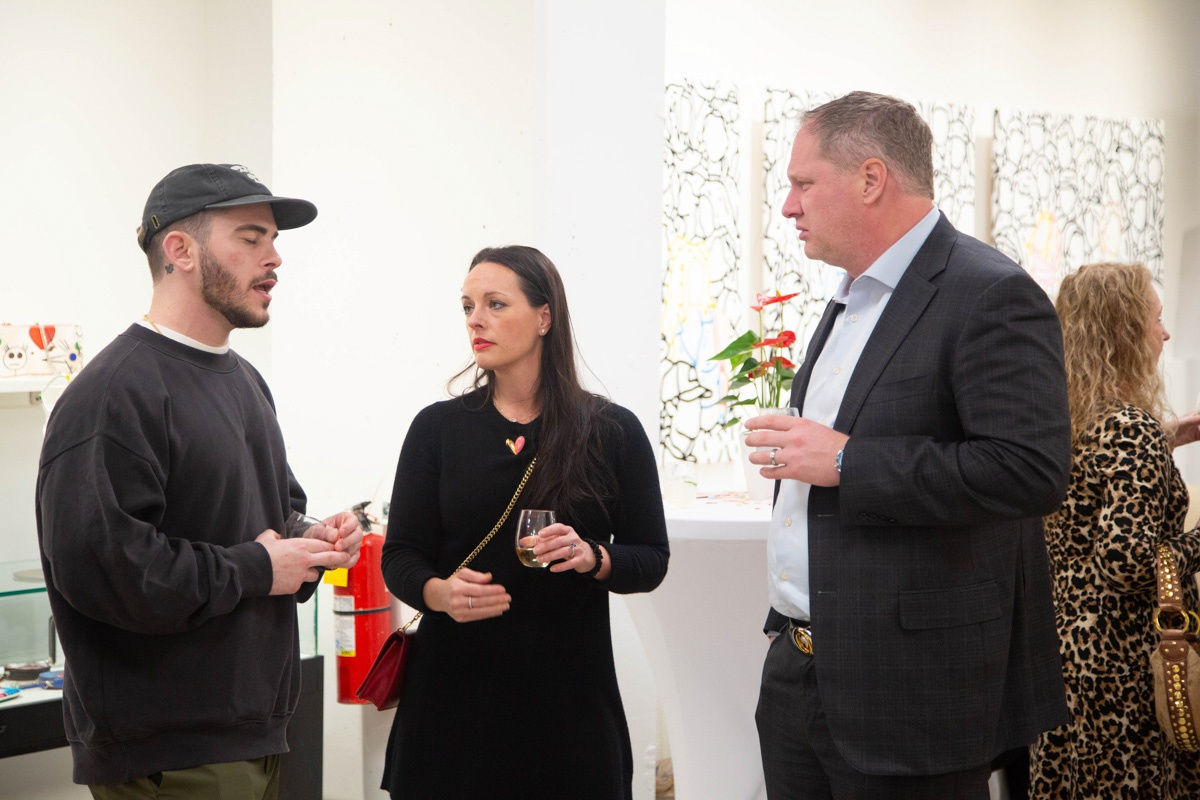 People in Carousel Fine Art's Atlanta gallery space during the spotlight exhibition for John Westbay titled "Love, Outside the Lines."
