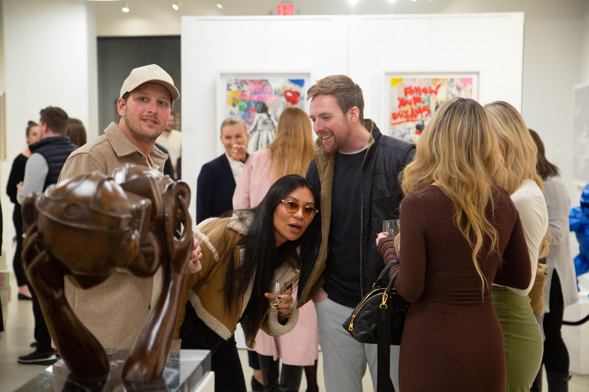 People in Carousel Fine Art's Atlanta gallery space during the spotlight exhibition for John Westbay titled "Love, Outside the Lines."