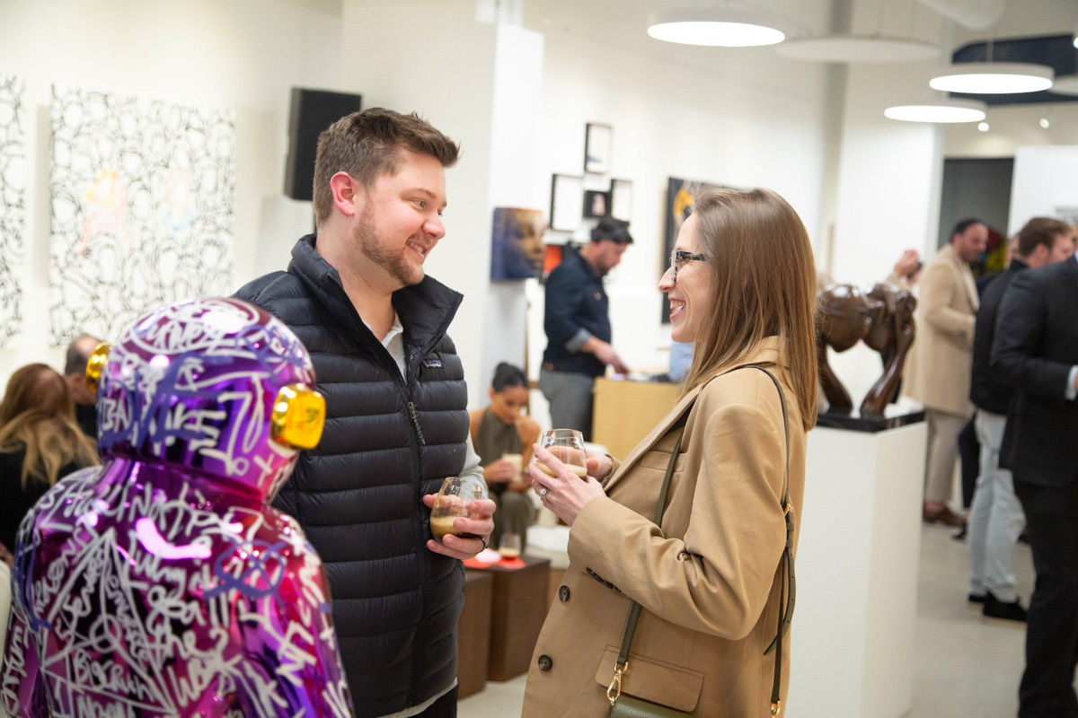 People in Carousel Fine Art's Atlanta gallery space during the spotlight exhibition for John Westbay titled "Love, Outside the Lines."