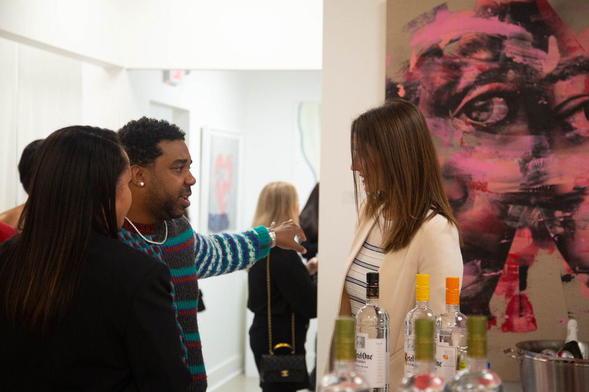 People in Carousel Fine Art's Atlanta gallery space during the spotlight exhibition for John Westbay titled "Love, Outside the Lines."