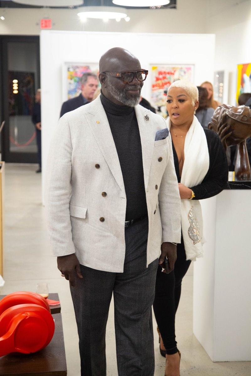 Man in Carousel Fine Art's Atlanta gallery space during the spotlight exhibition for John Westbay titled "Love, Outside the Lines."