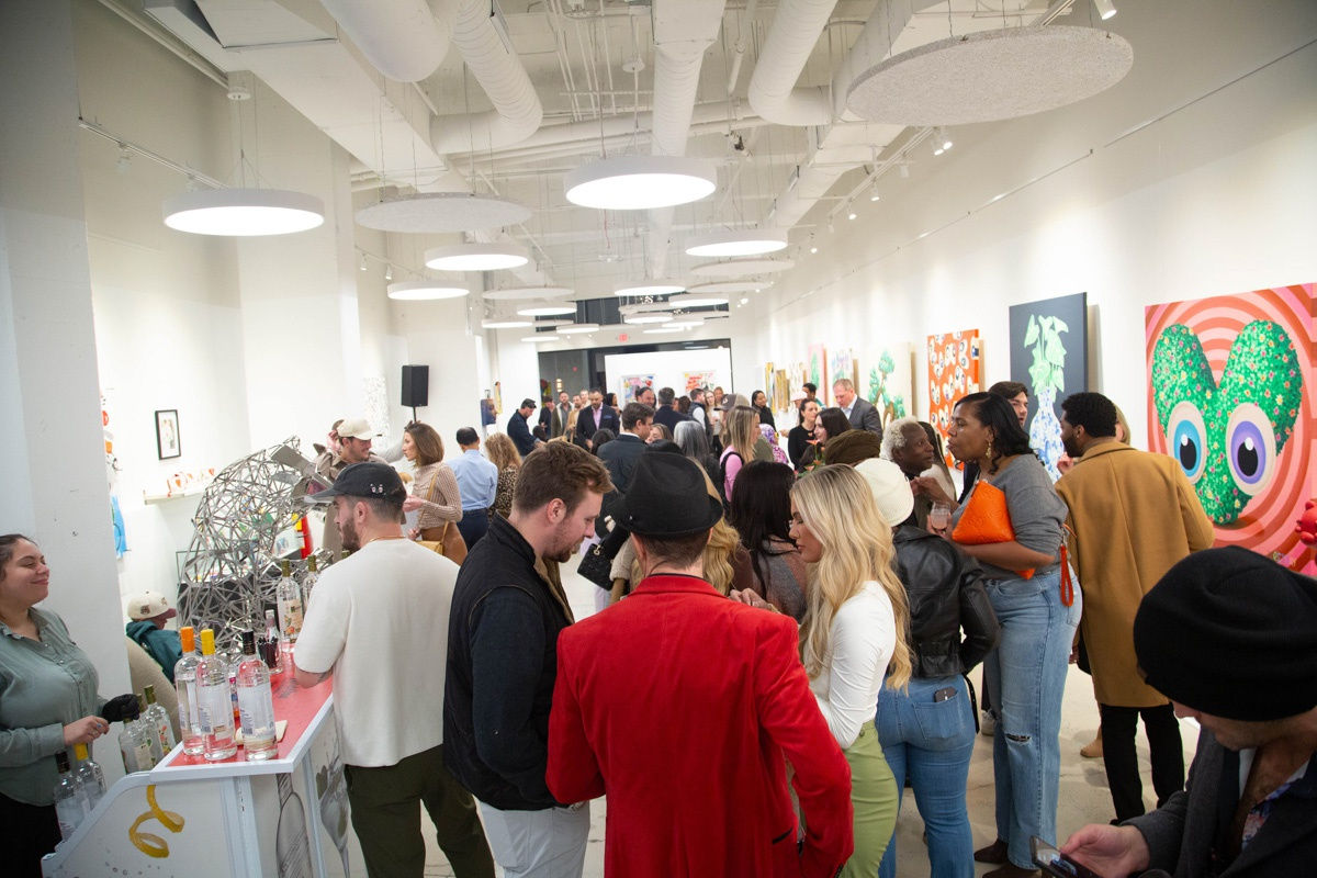 People in Carousel Fine Art's Atlanta gallery space during the spotlight exhibition for John Westbay titled "Love, Outside the Lines."