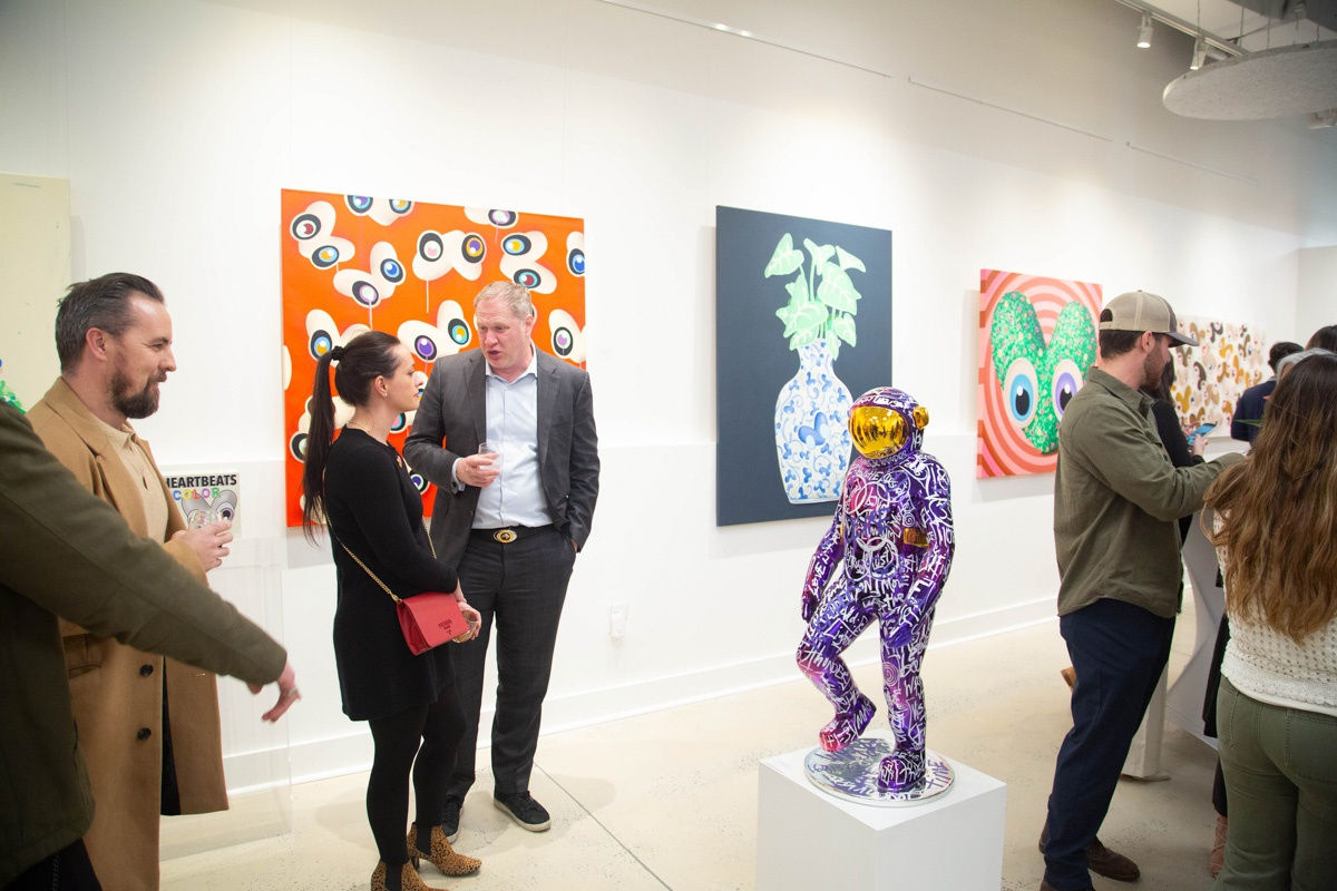 People in Carousel Fine Art's Atlanta gallery space during the spotlight exhibition for John Westbay titled "Love, Outside the Lines."