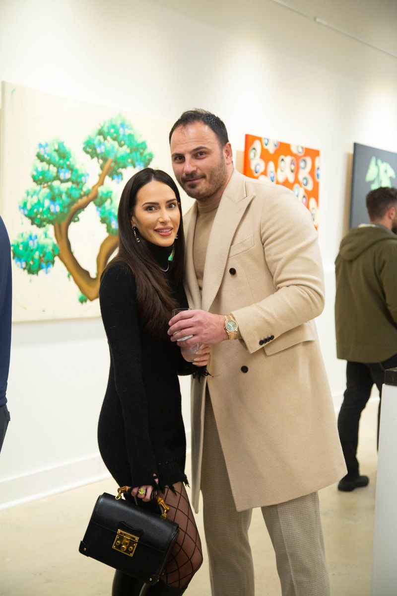 People posing in Carousel Fine Art's Atlanta gallery space during the spotlight exhibition for John Westbay titled "Love, Outside the Lines."