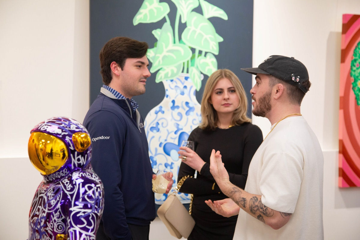 People in Carousel Fine Art's Atlanta gallery space during the spotlight exhibition for John Westbay titled "Love, Outside the Lines."