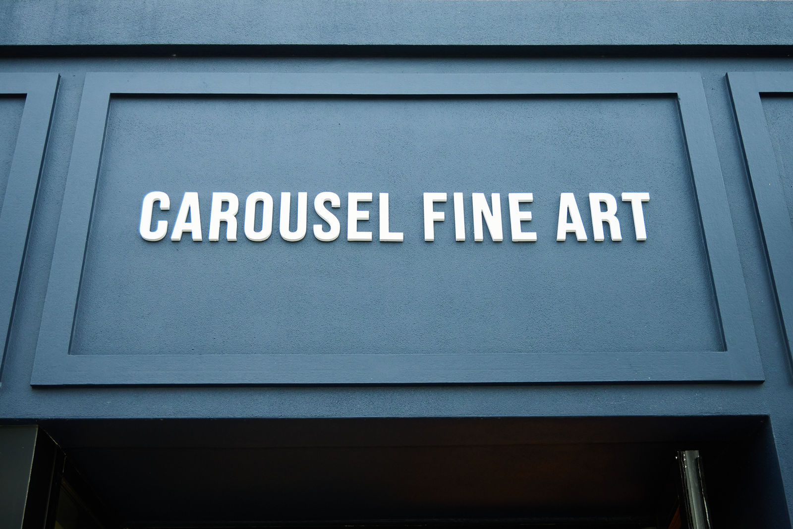 Close-up of Carousel Fine Art exterior sign at Nora grand opening VIP event.