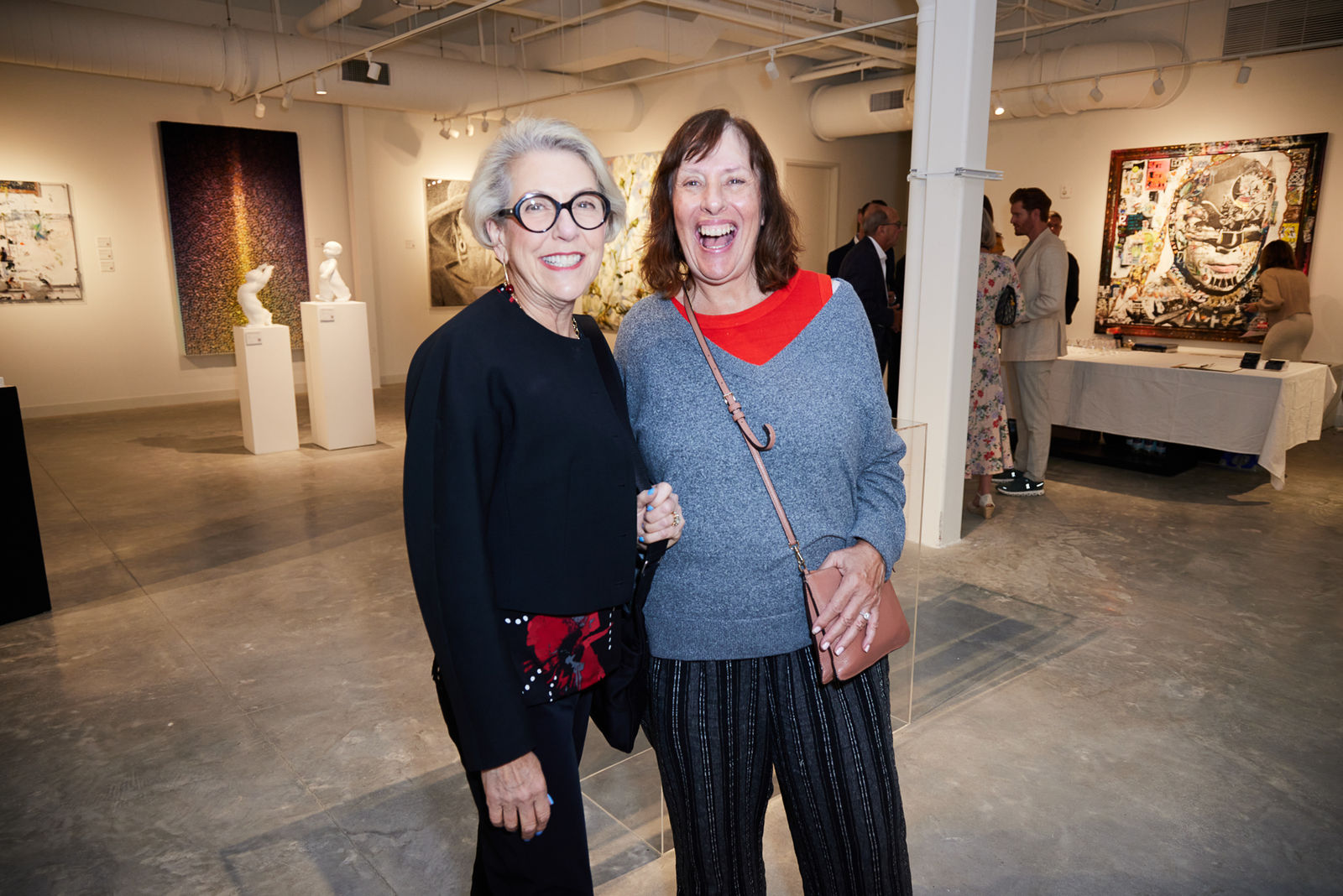 Group of guests enjoying cocktails while surrounded by Sylvain Tremblay textured paintings in West Palm Beach NORA gallery.