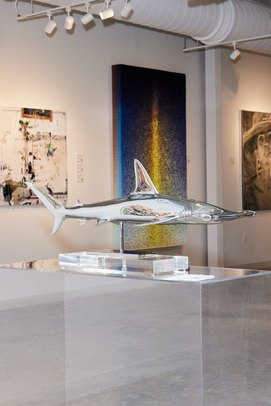 Christopher Schulz shark sculpture featured in front of work by Zhuang Hong Yi at Nora District opening event.