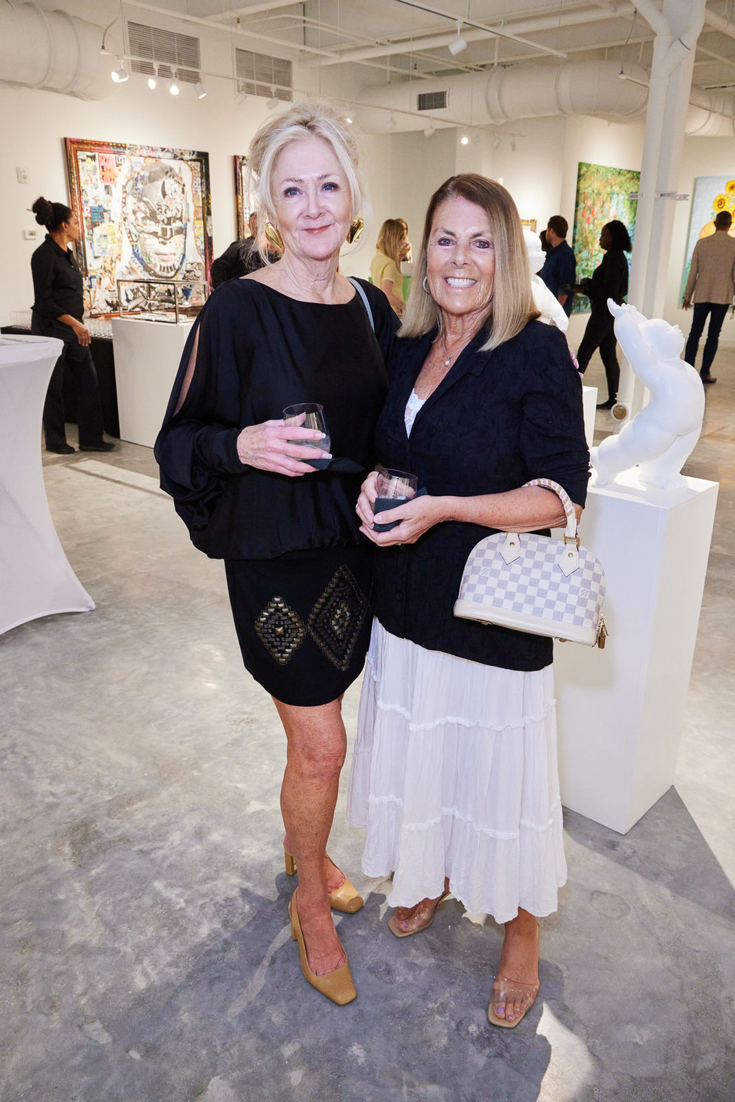 VIP guests discussing Sylvain Tremblay layered abstract-figurative work at our NORA District West Palm Beach event.