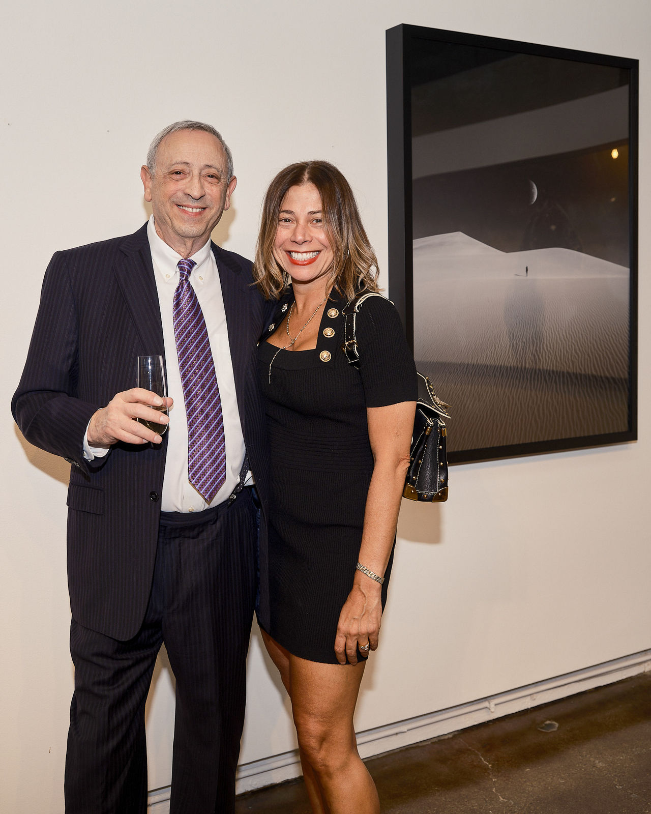 Guests dressed in evening attire posing for a picture at the Jason M. Peterson and Rolls-Royce event in River North.