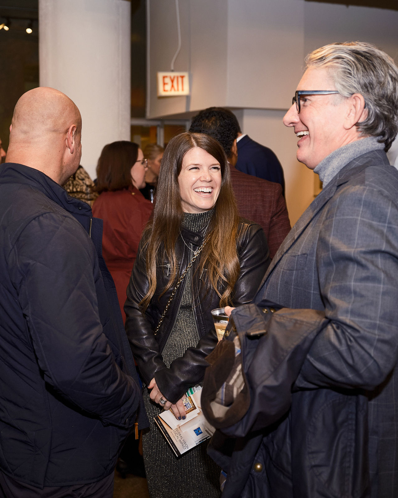 Client listening closely as advisor explains edition details of a Jason M. Peterson city-at-night print.