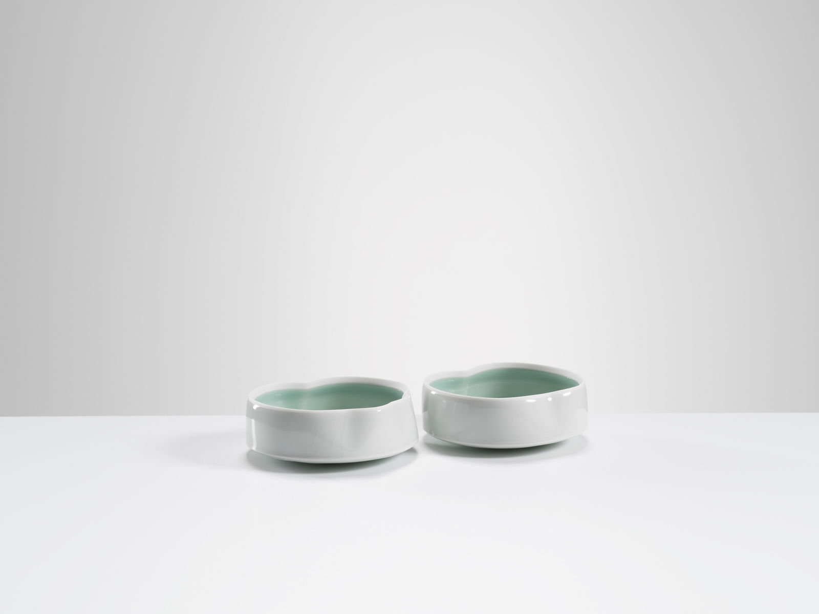 Chris Keenan, 21-22 Pair of Celadon Cloud dishes with deeper celadon 'script'