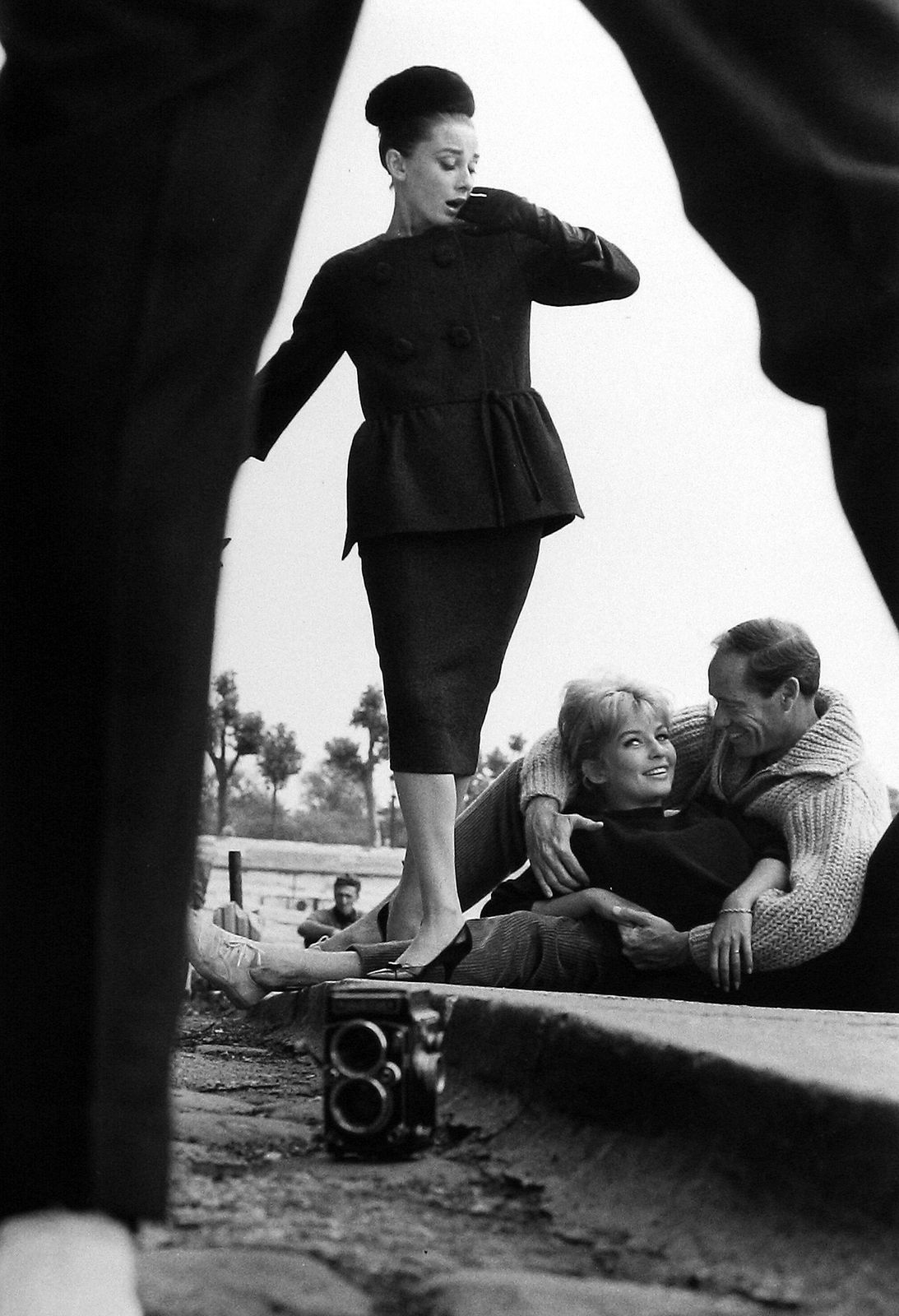 Henry Wolf, Audrey Hepburn view through legs with couple, c.1959