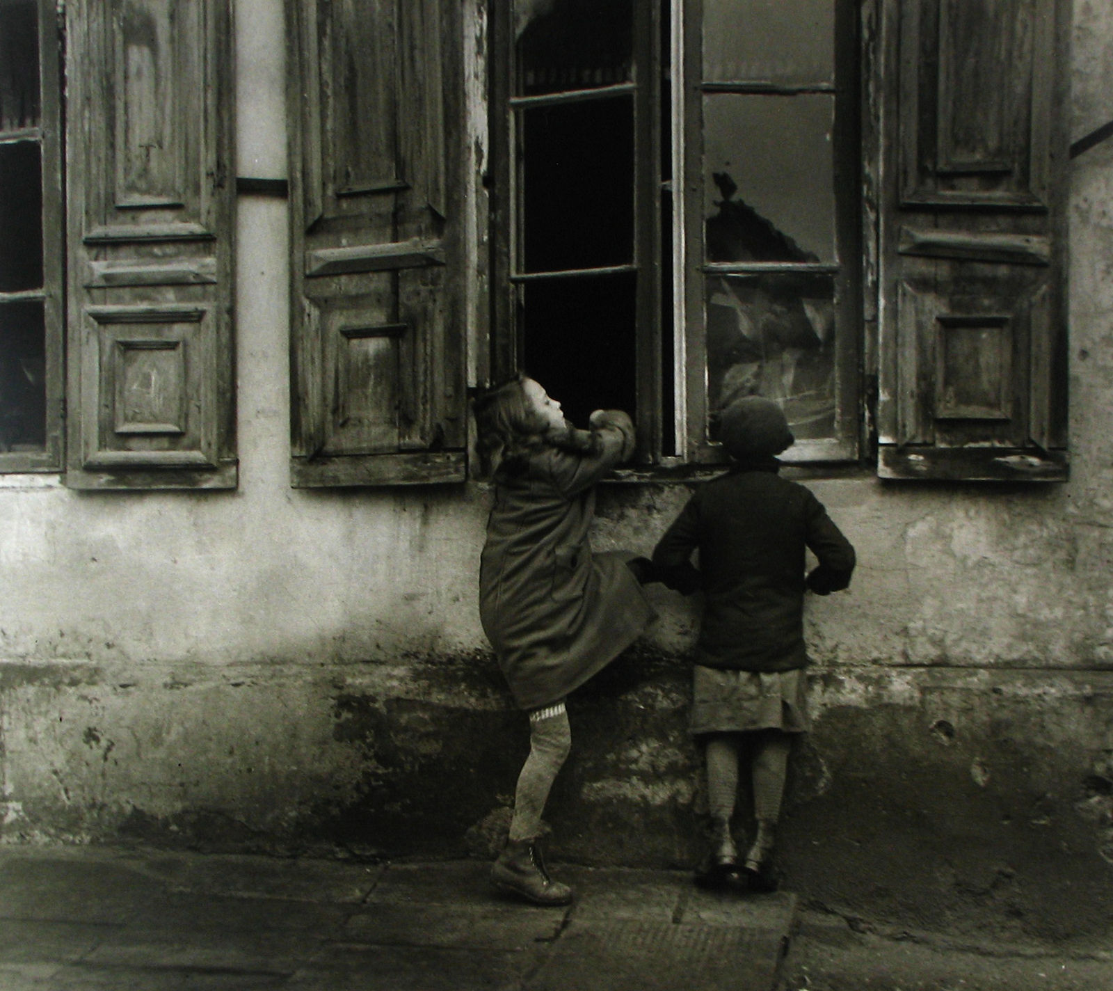Roman Vishniac, These girls were sent out to play, but they preferred to watch Mother at work inside, Slovakia, 1935
