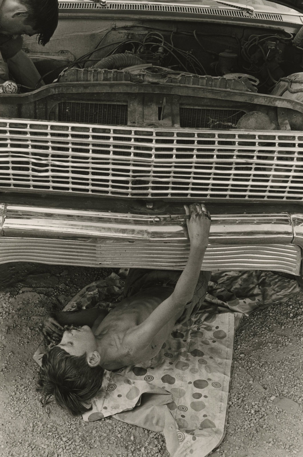 William Gedney, Bill Cornett, Jr. under car, Kentucky, 1972