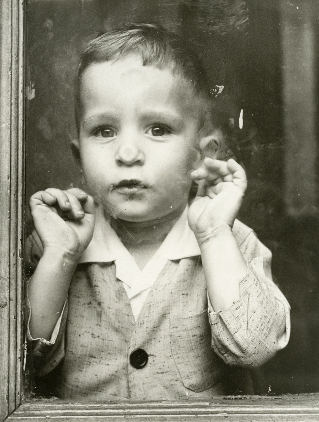 Vivian Maier, Untitled (child pressing face against window), n.d.