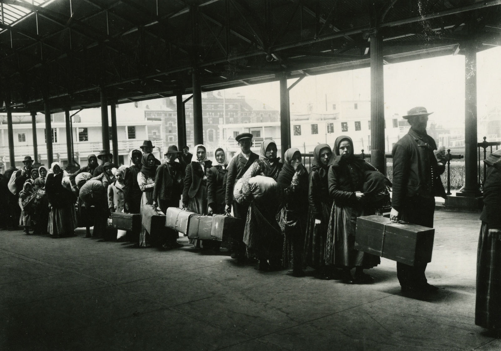 Photographer Unknown, Immigrants at Ellis Island awaiting a ferry to the city, c.1900
