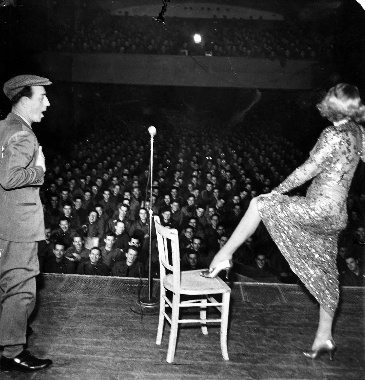 George Silk, Marlene Dietrich posing seductively as she exhibits her famous shapely leg while entertaining troops in Germany, 1945