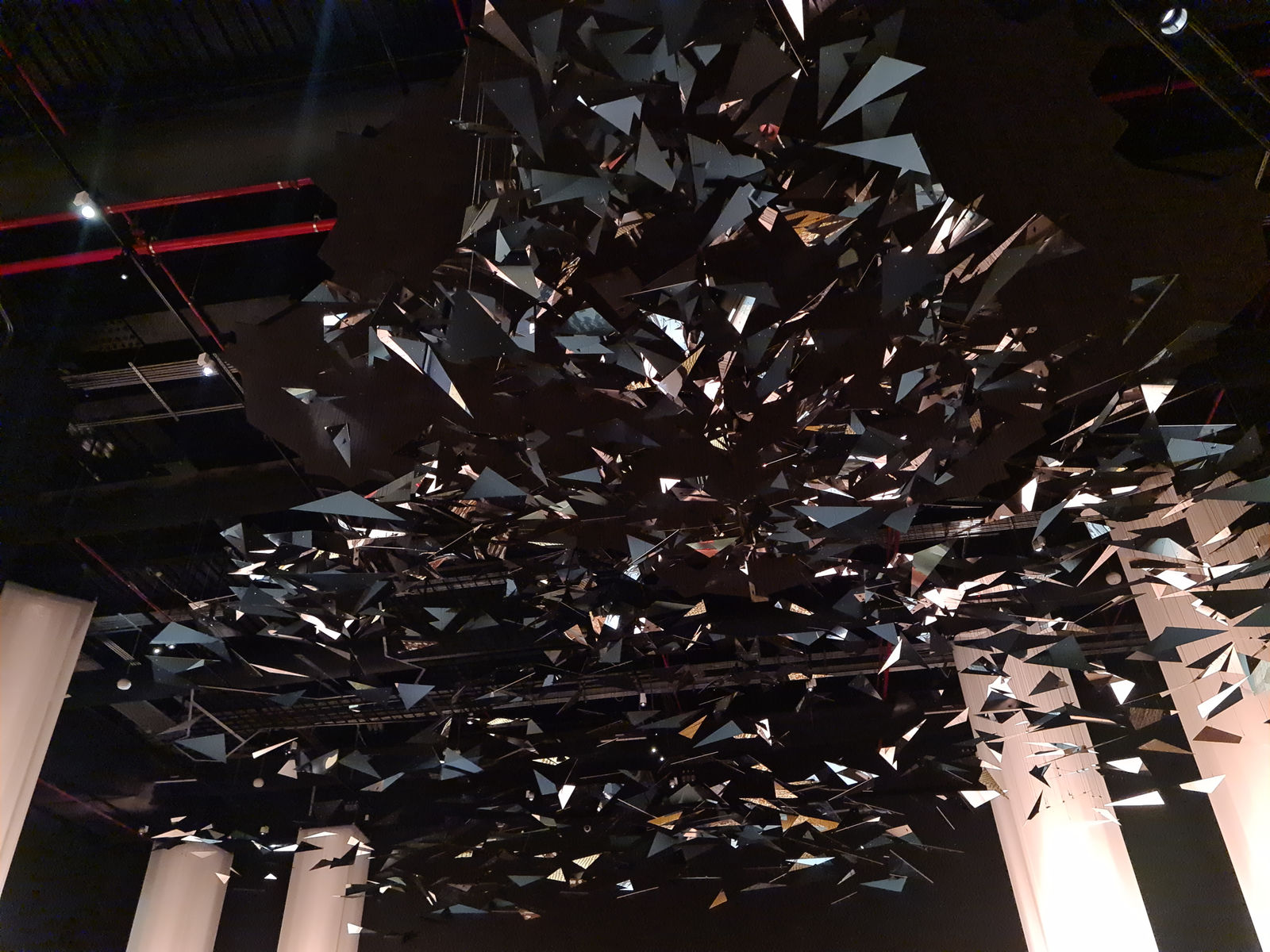 Timo Nassseri. Echoes of the Skies, 2025. Polished stainless steel, plywood, cables. h. 3.9× w. 10× d. 10 m (footprint central body) h. 3.9× w. 14× d. 4 m (footprint tail)