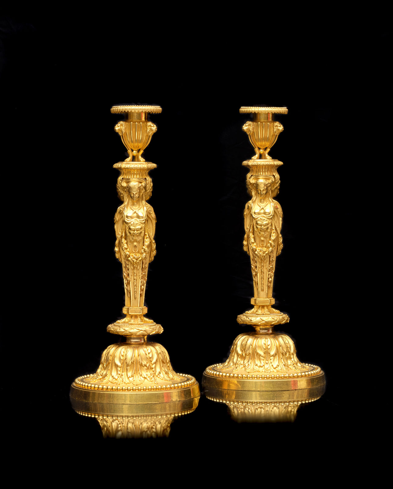 Jean-Démosthène Dugourc, A pair of Louis XVI style gilt bronze candlesticks after a model by Jean-Démosthène Dugourc, Paris, date circa 1820