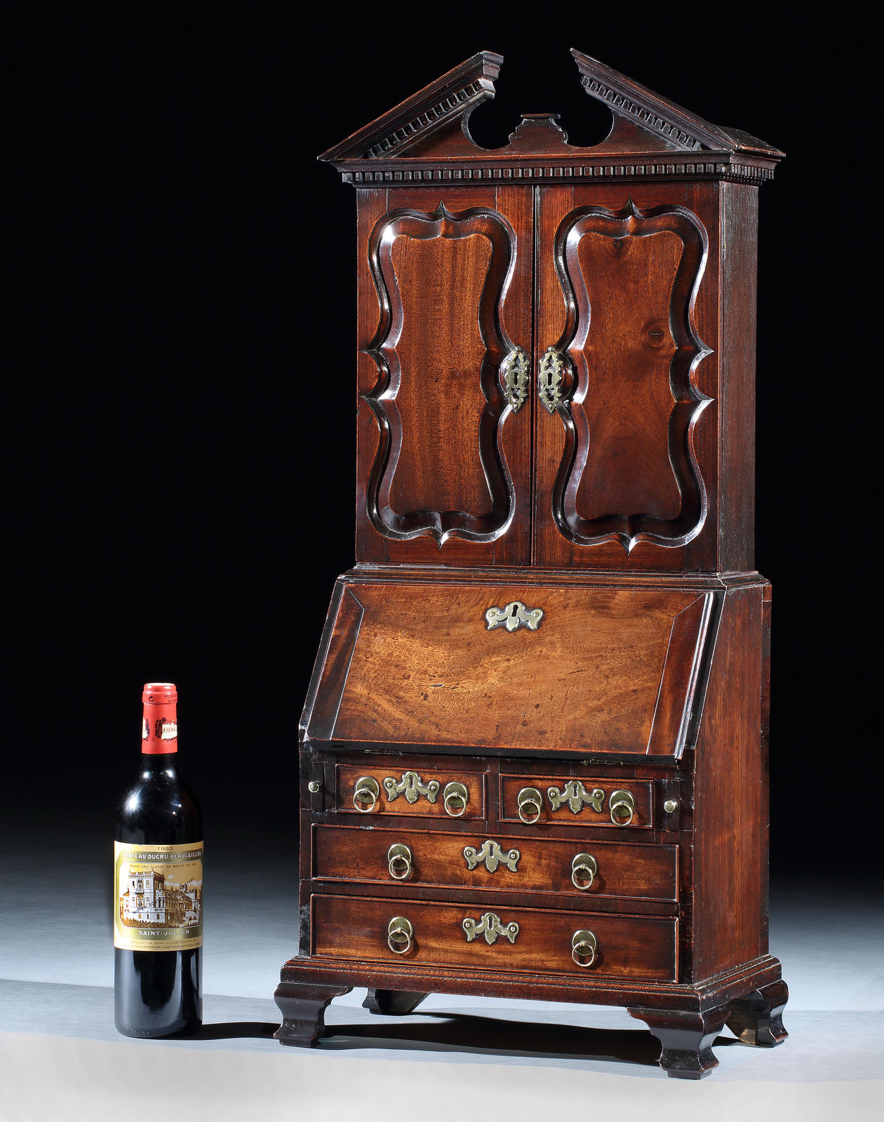 A GEORGE II MINIATURE MAHOGANY BUREAU-BOOKCASE, ENGLISH, CIRCA 1750