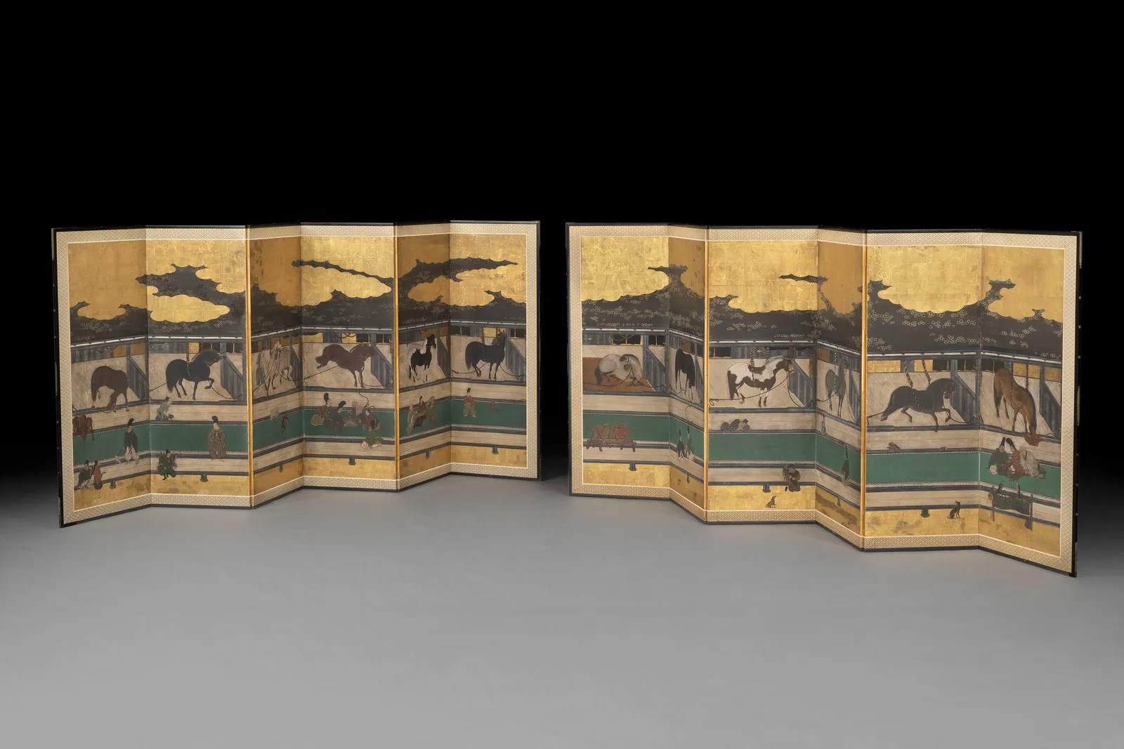 A PAIR OF SIX-FOLD BYŌBU (SCREENS) DEPICTING THE HORSE STABLE, JAPAN, MOMOYAMA (1573 - 1615) - EDO PERIOD (1603 - 1868), c. 1600