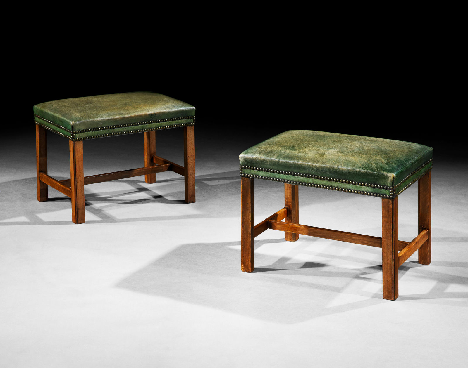 A PAIR OF GEORGE III MAHOGANY STOOLS, ENGLISH, CIRCA 1770