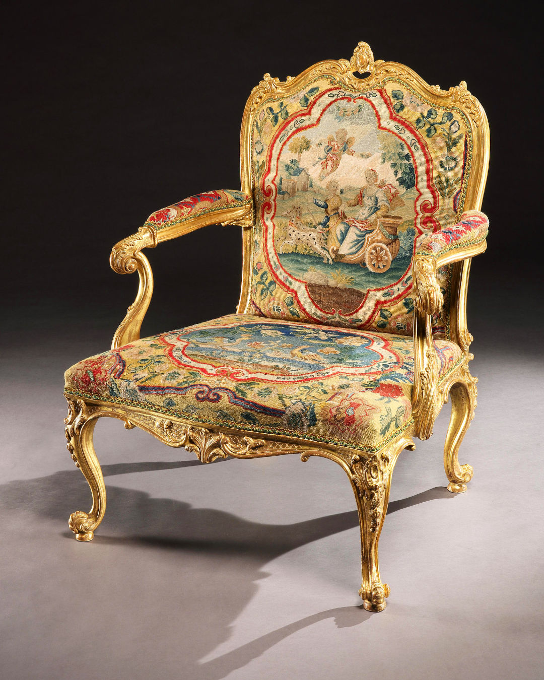 A GEORGE II GILTWOOD ARMCHAIR, The chair: English, circa 1755  The needlework: French, circa 1750
