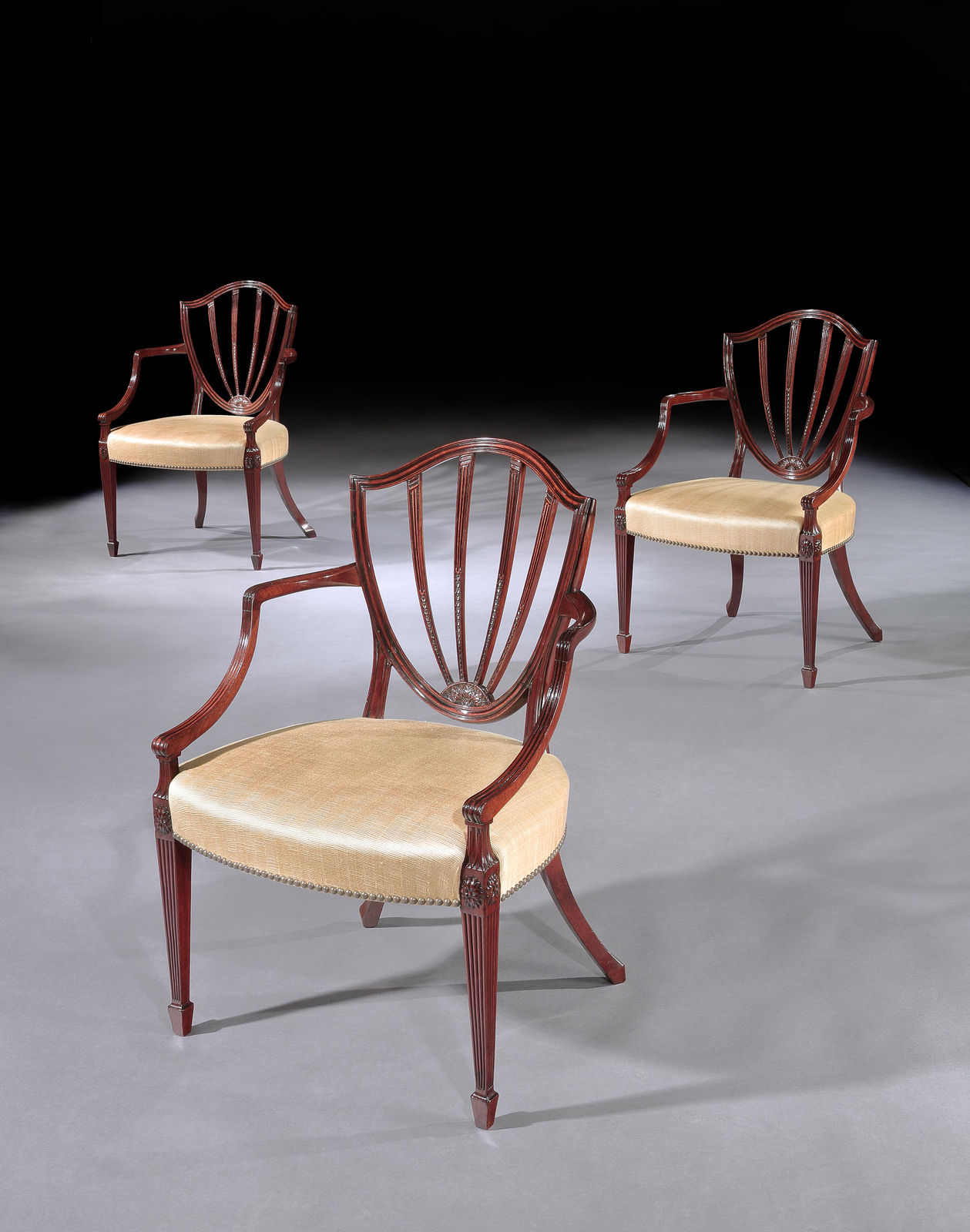 A SET OF SIX GEORGE III MAHOGANY ARMCHAIRS, English, circa 1790