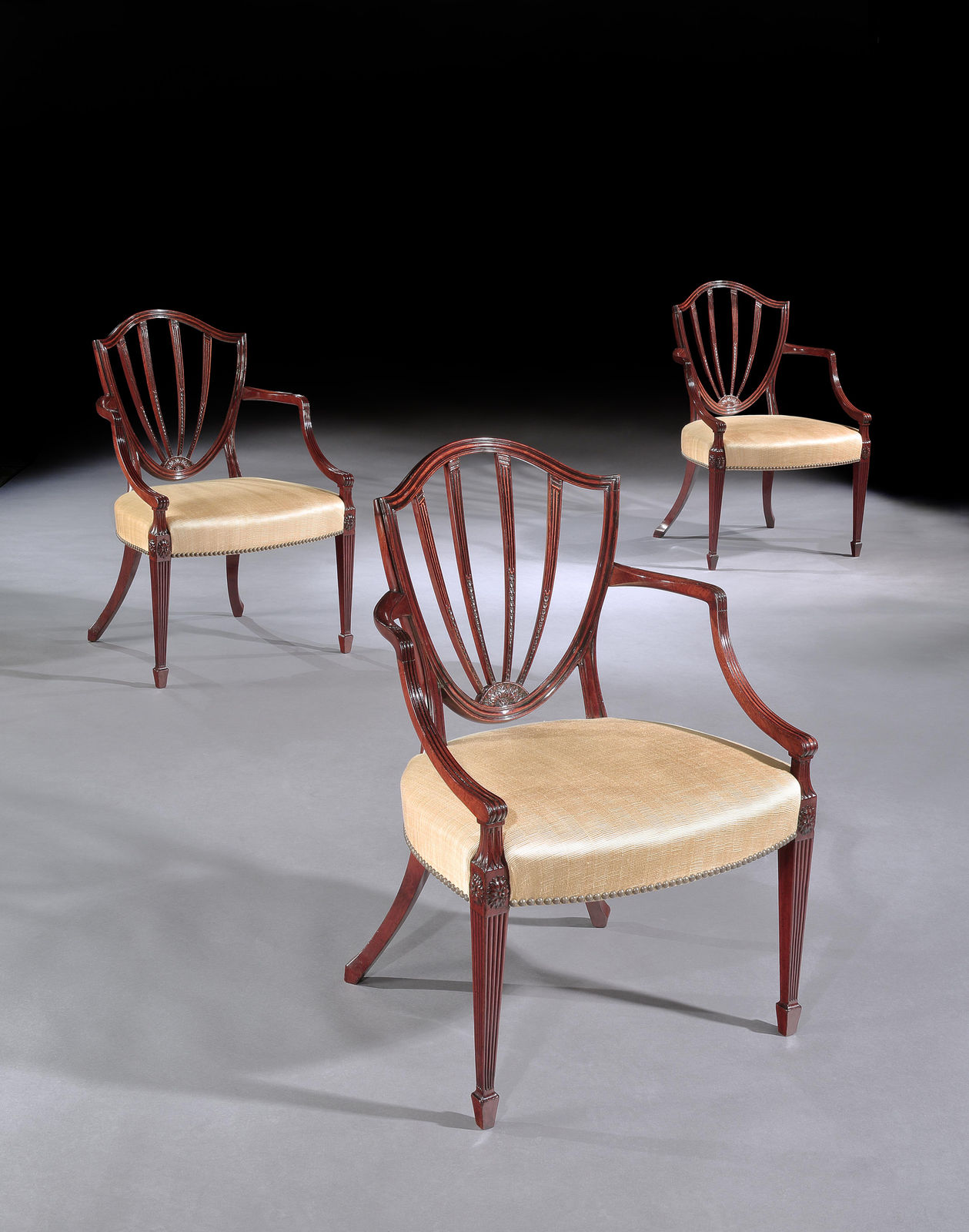 A SET OF SIX GEORGE III MAHOGANY ARMCHAIRS, English, circa 1790