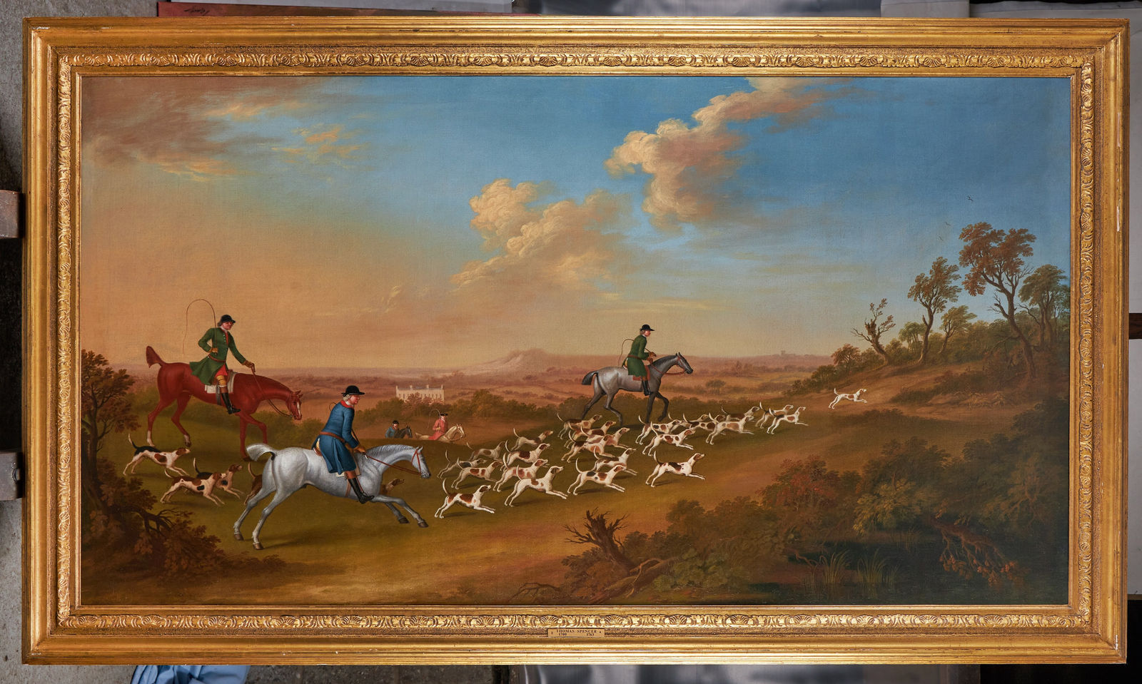 David Lyon, Huntsmen following hounds towards a covert, a country house in the distance